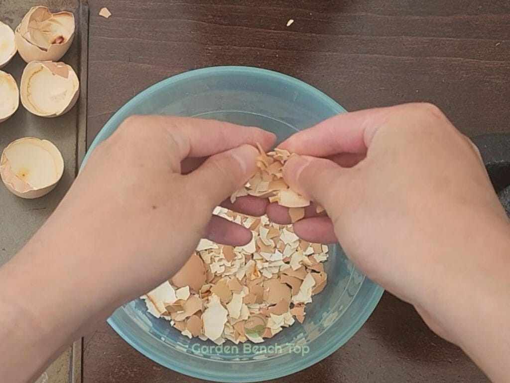 Crush eggshells with hands