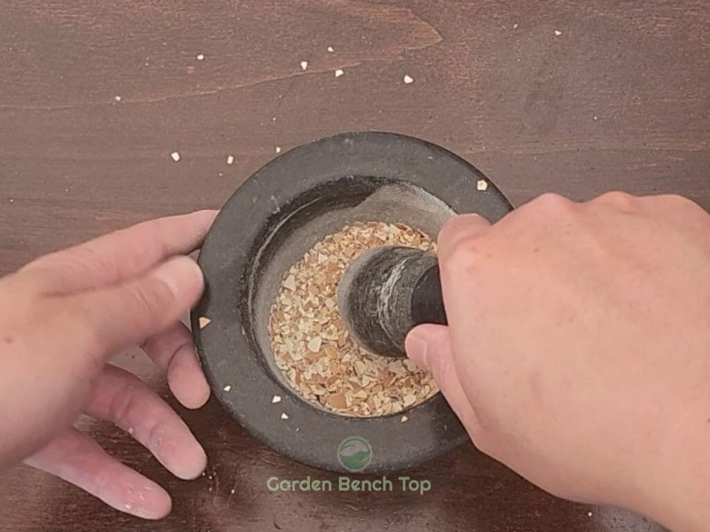 Grind eggshells using mortar & pestle